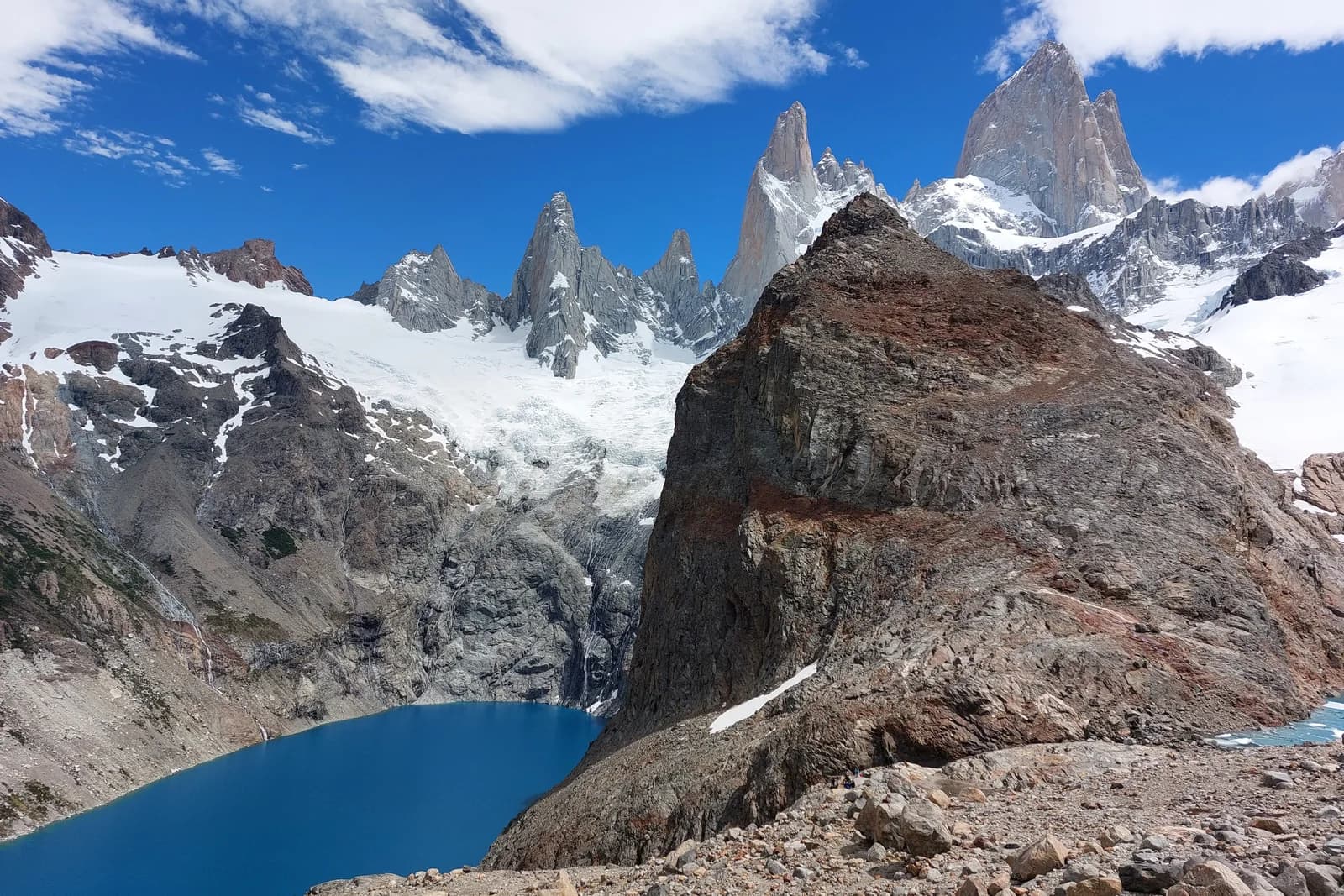 Mount Fitz Roy above a blue lagoon and rocky valleys in Argentine Patagonia
